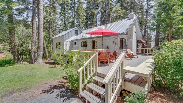 A cabin with a deck, outdoor seating, and a red umbrella. - < 2 Blocks to Lake Tahoe: Family Home Near Skiing (Homewood)