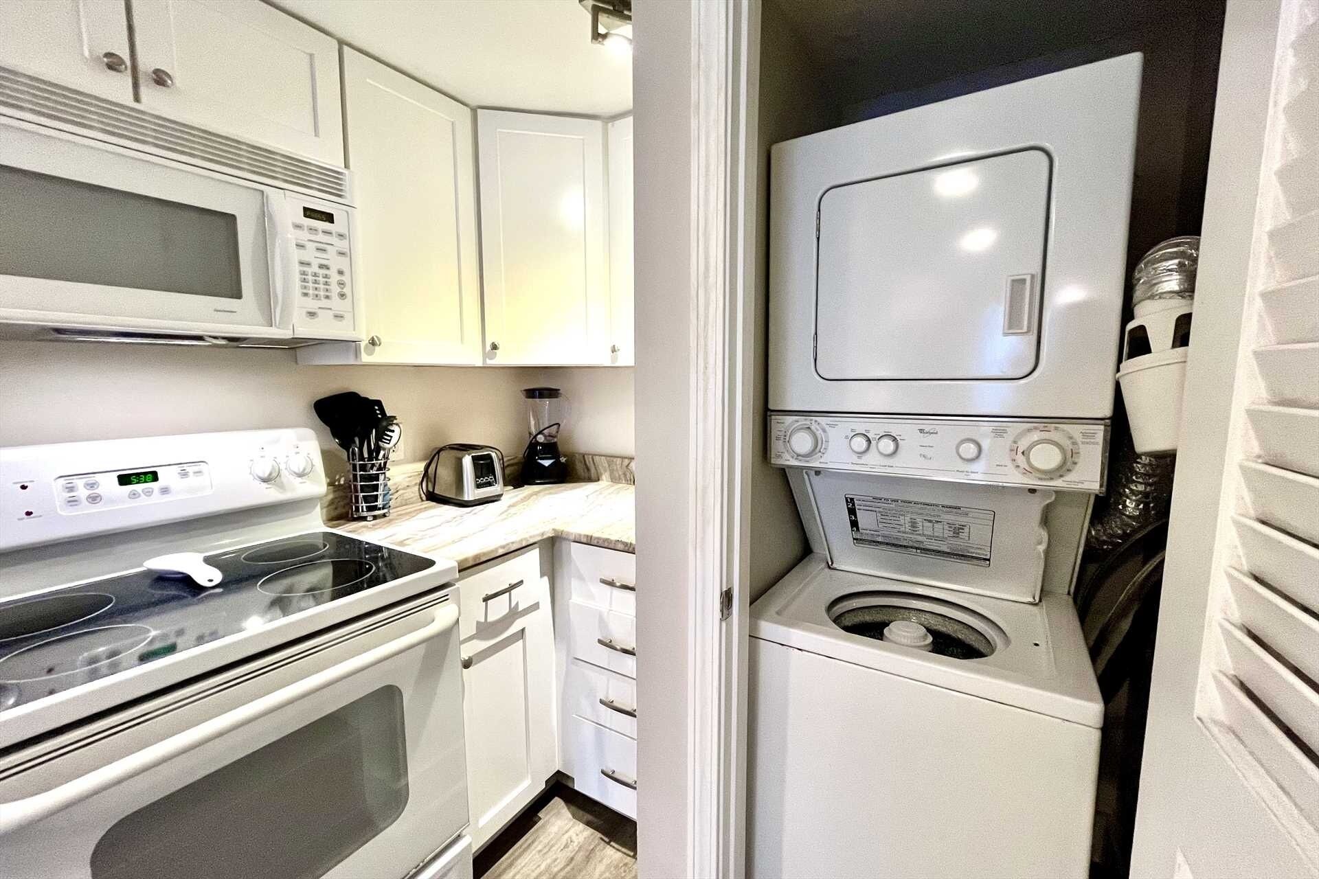 A compact kitchen with a microwave, toaster, and a small oven.