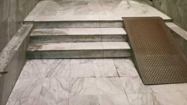A marble staircase leading to a lobby with a glass door entrance. - Orchida Al Hamra (Riyadh)