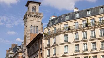 A historic building with a prominent tower and multiple balconies.