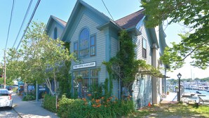 A two-story building with a sign reading "The Cove Gallery".