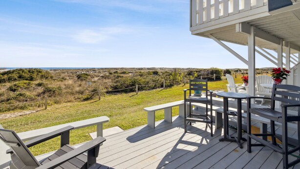 Una terraza con asientos al aire libre y vistas a la playa.