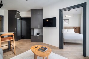 Relax in a stylish room with a comfortable bed, flat-screen TV, and dining area.