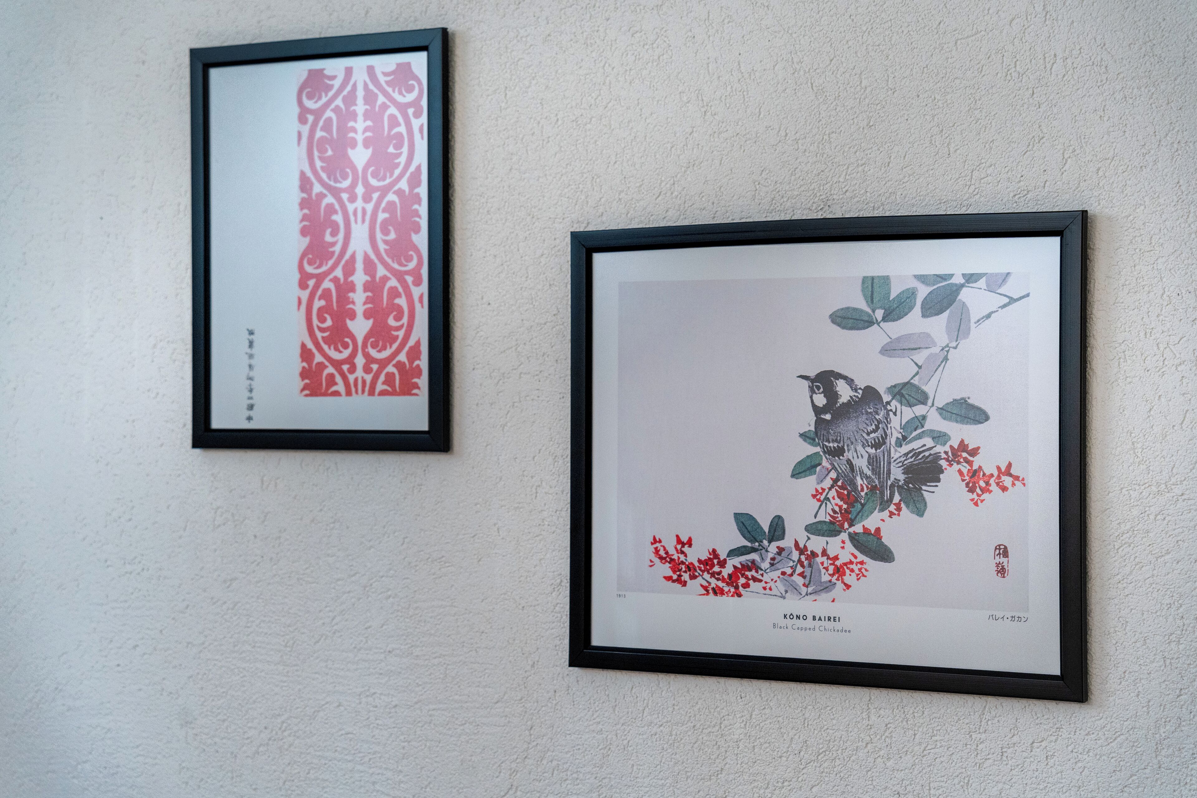 Two framed artworks on a wall.