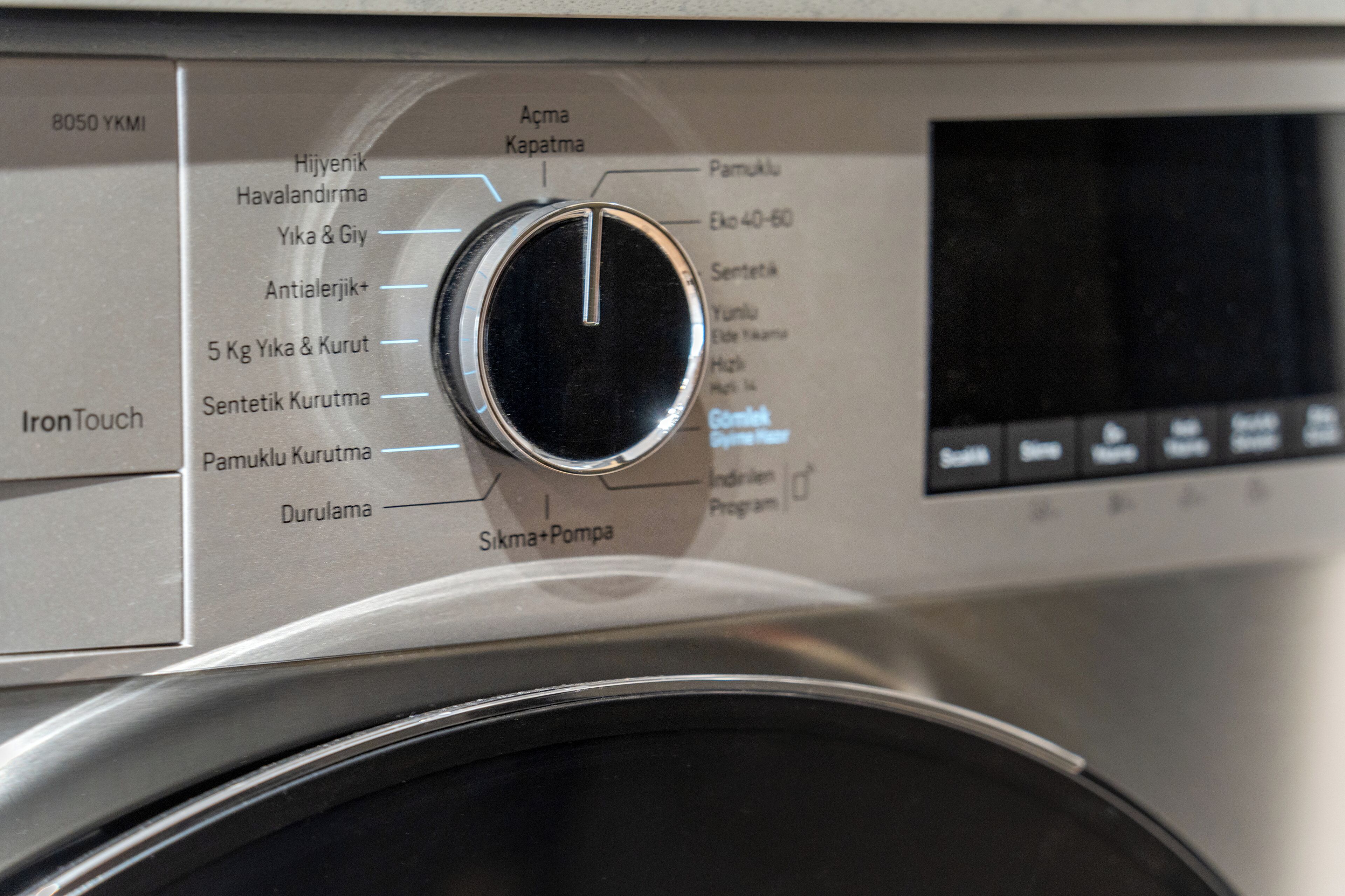 A control panel with various settings and labels, including "IronTouch" and "Sikma+Pompa".
