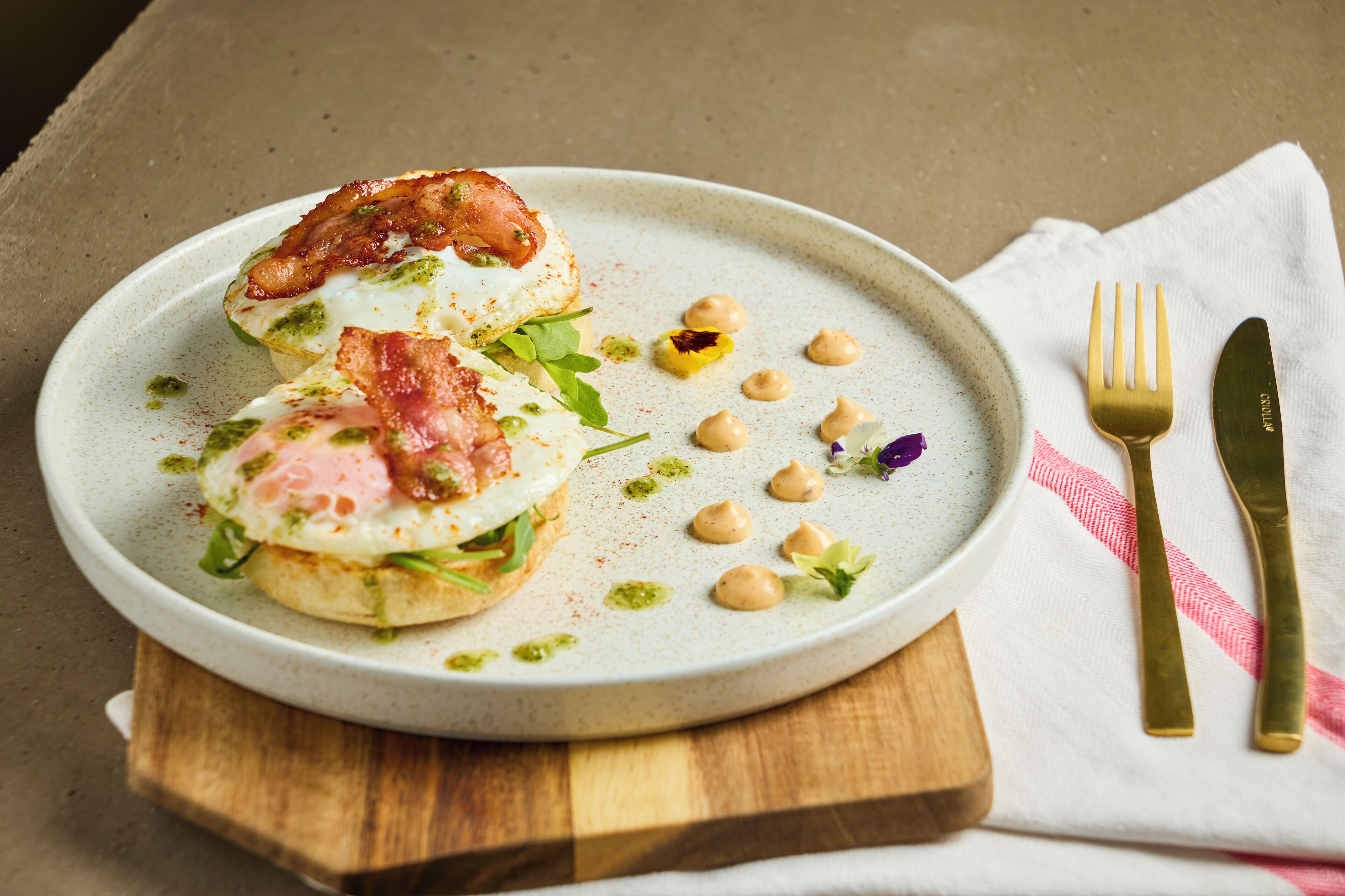 A plate of food with a fork and knife on a napkin.