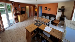 A compact living space with a dining area, kitchenette, and a sofa. - Titmouse, Gîte in Dordogne (Saint-Avit-Sénieur)
