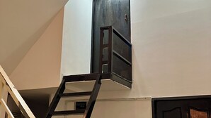 A staircase with a metal handrail leading to a landing. - Cannarata (Phnom Penh)