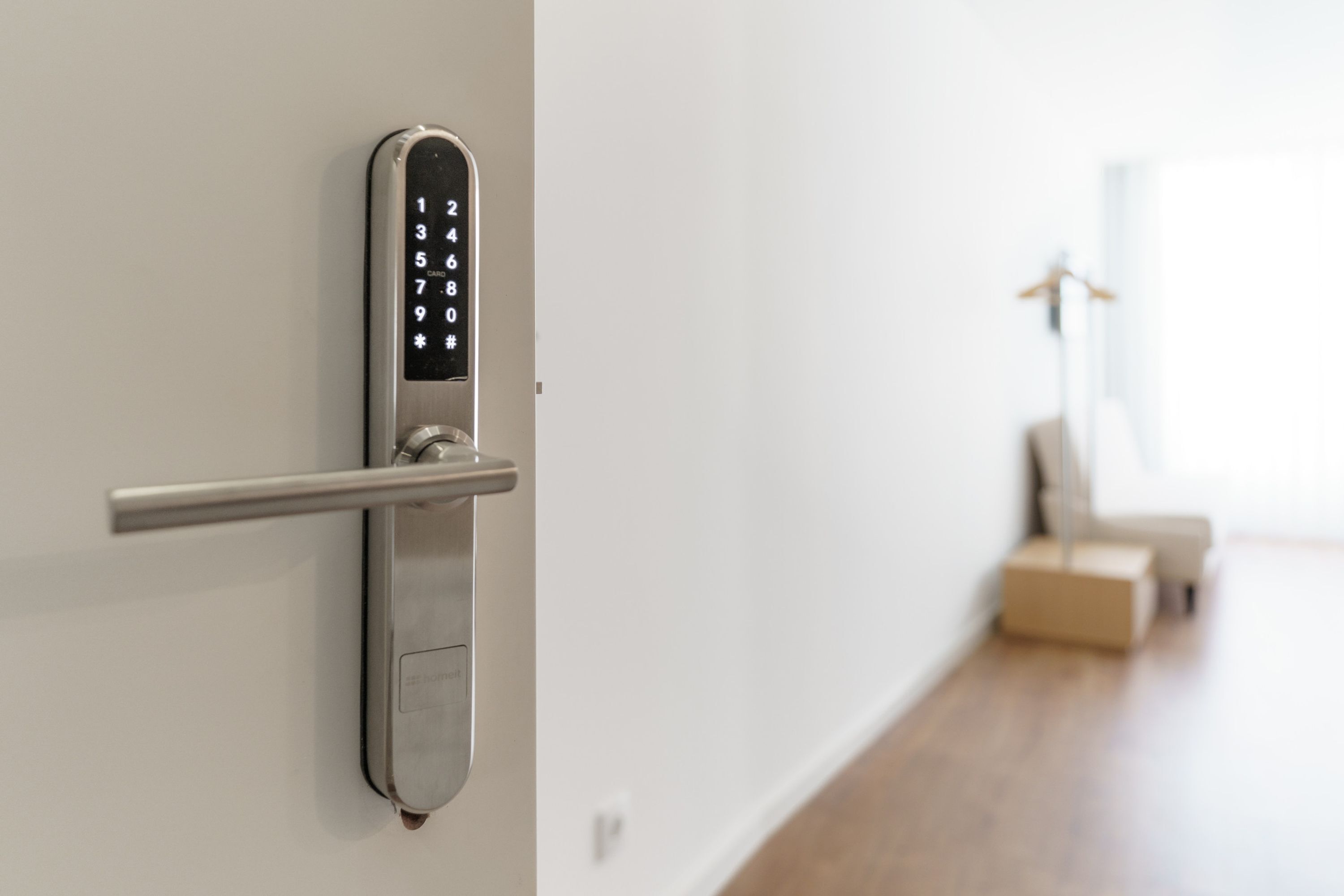 A modern door with a numeric keypad lock and a handle.