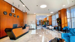 A hotel lobby with a reception desk, seating area, and large windows. - ADAY Hotel Casablanca (Casablanca)