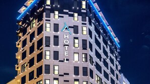 A multi-story hotel with a modern design, featuring a prominent 'HOTEL' sign on the facade, large windows, and a corner location with a street view. - ADAY Hotel Casablanca (Casablanca)