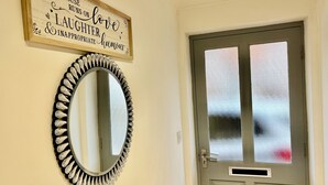 A door with frosted glass panels and a mirror with a decorative frame.