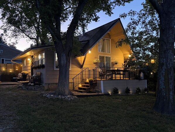 A two-story house with a balcony, a staircase, and a porch area.