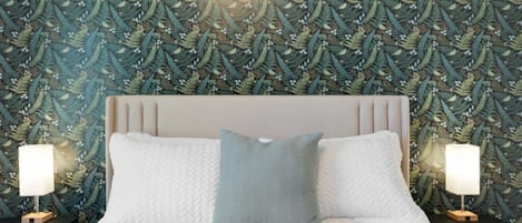 A bed with a white quilt and two pillows, flanked by nightstands with lamps, against a wall with a leafy pattern.