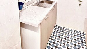 A compact kitchen with a sink, countertop, and cabinets. - Close Cinecittà studios suitable for families and pets Metro 5 minutes walking (Roma)