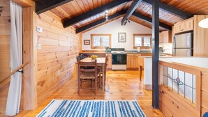 A cozy cabin-style kitchen with wooden walls and a sloped ceiling. - Bring the dog-colorful SacoRiver (Bartlett)