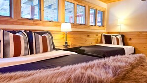 A cozy room with a bed, a nightstand, a lamp, and a window with a view of the outside. - Bring the dog-colorful SacoRiver (Bartlett)