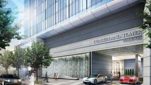 A modern building with a glass facade, labeled 'CUMBERLAND TOWER RESIDENCES.'