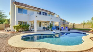 A two-story house with a swimming pool, outdoor furniture, and a clear blue sky. - Hike & Golf! Cave Creek Retreat w/ Backyard Oasis (Cave Creek)