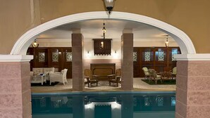 A pool area with a lounge seating arrangement, a fireplace, and decorative lighting. - Heritage valley. (New Cairo 1)