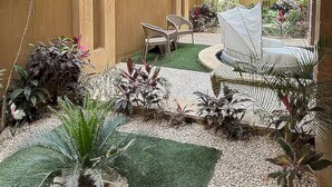A courtyard with a seating area, palm trees, and a water feature. - Heritage valley. (New Cairo 1)