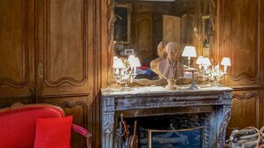 A room with a large mirror, a fireplace, and a red chair. - Lovely home in Ingouville sur Mer (Ingouville sur Mer)