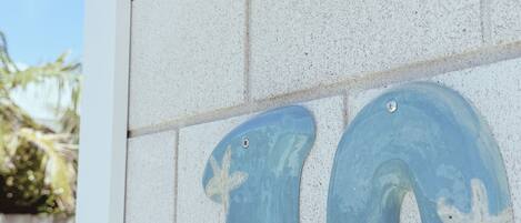 A wall with a large number '10' made of tiles, each featuring a starfish design.