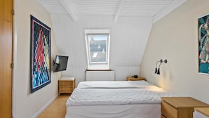 A bedroom with two beds, a TV, a window, and artwork on the walls. - 3 bedroom awesome home in Marstal (Marstal)