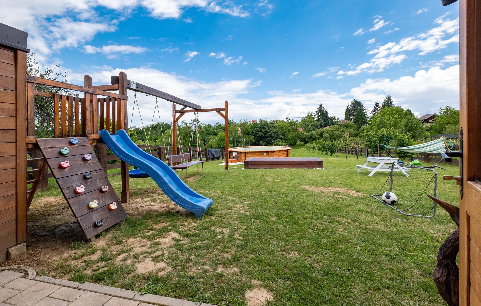 A playground with a slide, swings, and climbing structures.