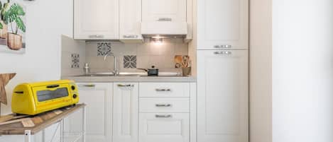 Fridge, coffee/tea maker, cookware/dishes/utensils