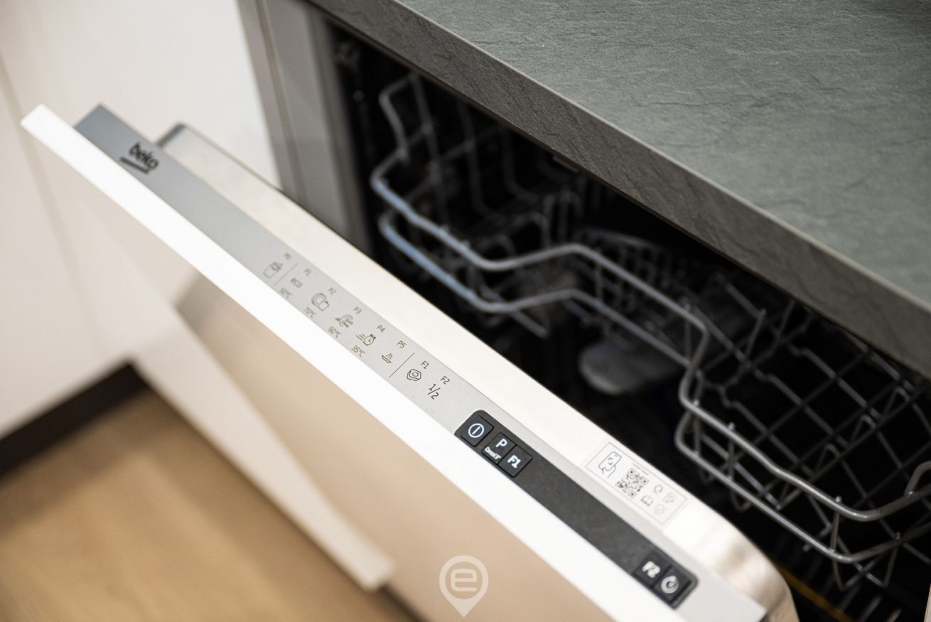 A dishwasher with a control panel and a metal rack.