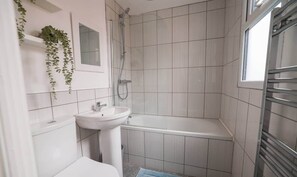 A bathroom with a white sink, a bathtub, and a shower. - City Centre House Near Attractions & Free Parking (Belfast)