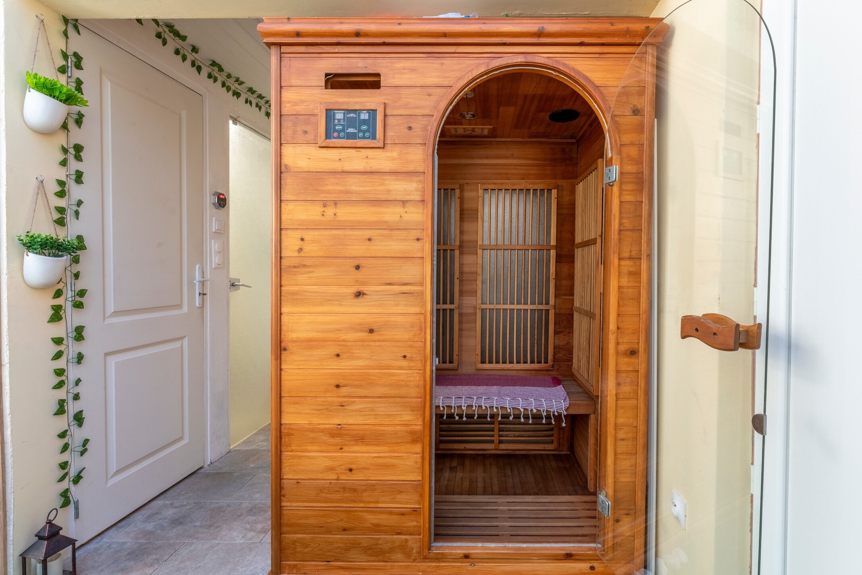 A wooden interior with a bench, a door, and a small window.