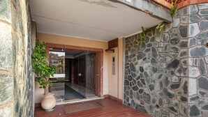 A stone wall, a potted plant, and a tiled entrance. - Apartment 'Carla' with Sea View and Balcony (Sanremo)