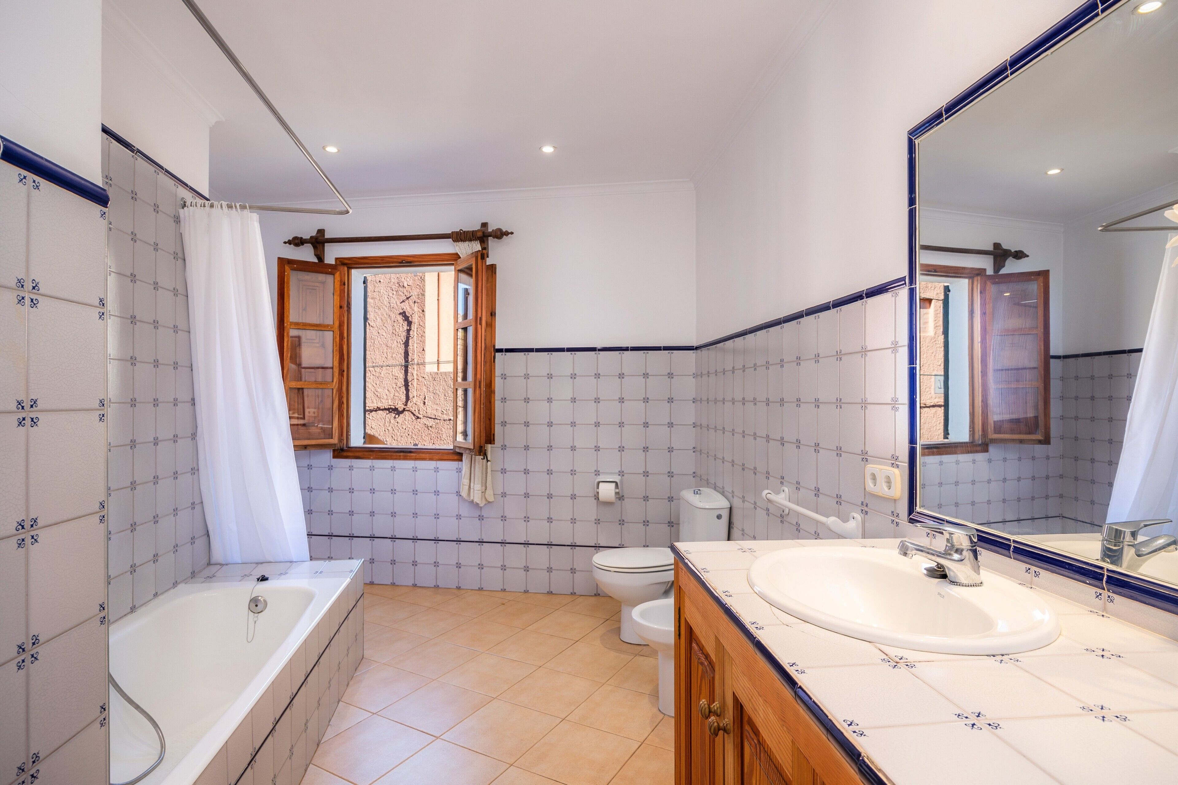 A bathroom with a bathtub, toilet, and sink.
