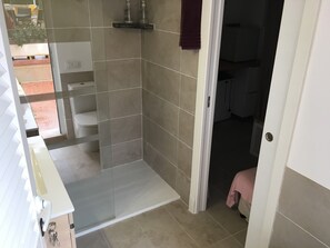A bathroom with a glass shower enclosure, a toilet, a sink, and a towel rack. - Holiday Home 'Mateu' with Private Pool, Wi-Fi and Air Conditioning (Colonia de Sant Pere)