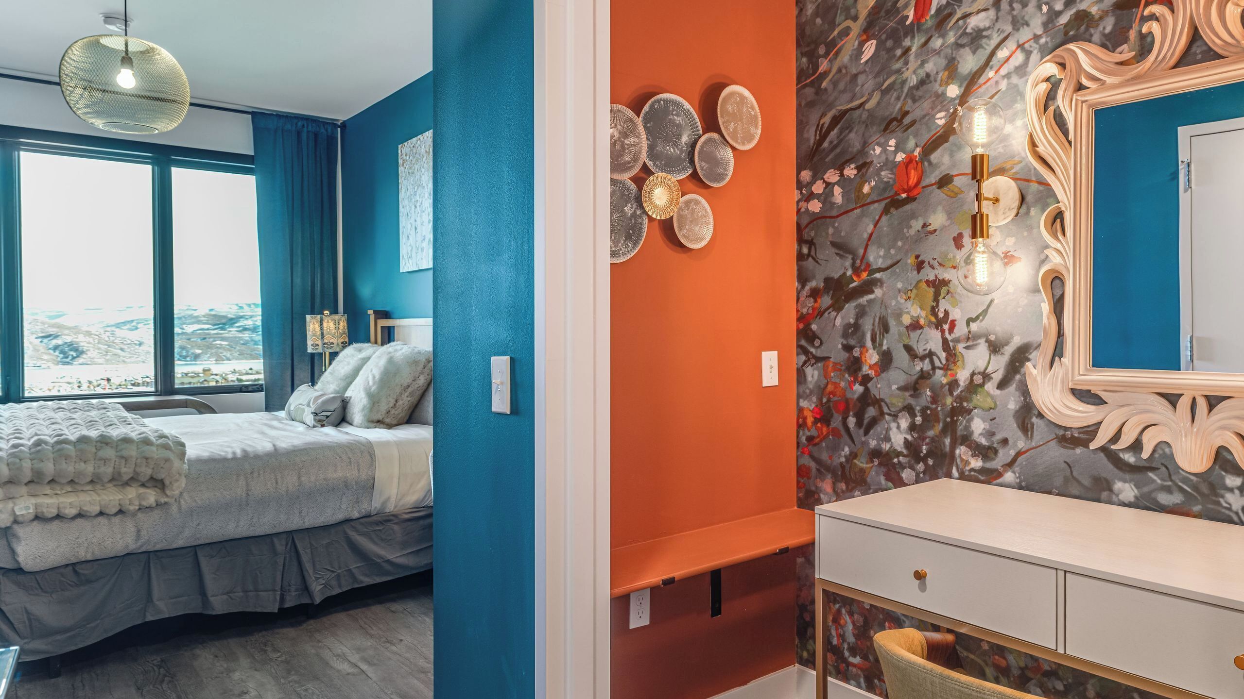 A bedroom with a bed, a dresser, and a mirror.