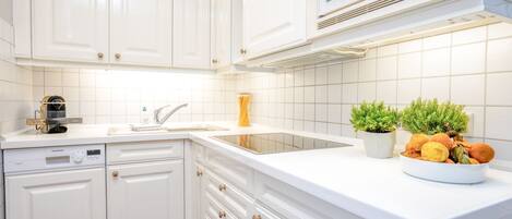 Fridge, stovetop, dishwasher, coffee/tea maker