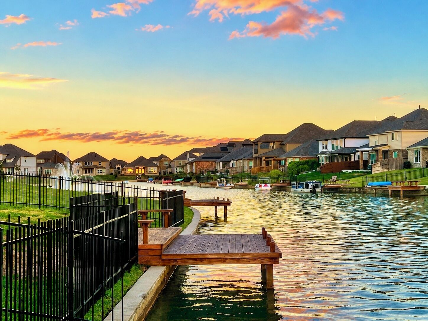 A residential area with houses, a body of water, and a dock.