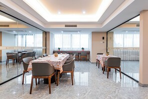 A conference room with a long table, chairs, and a glass partition. - Tianjie International Hotel (Guilin)