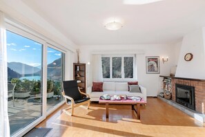 A spacious living room with a sofa, a coffee table, and a fireplace.