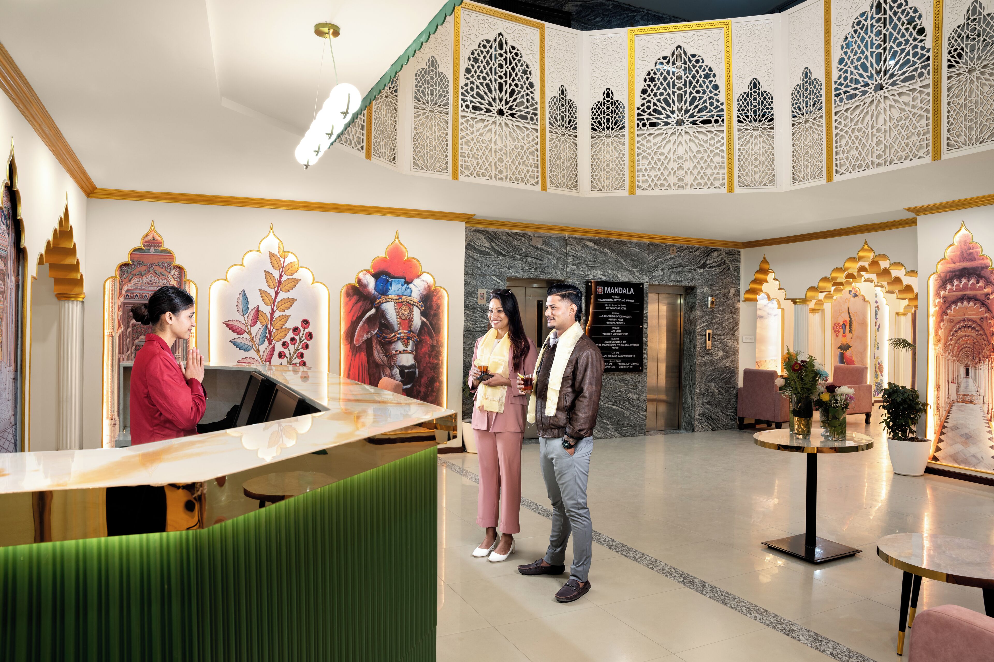 A reception area with a counter, a seating area with a round table, and decorative panels on the walls.