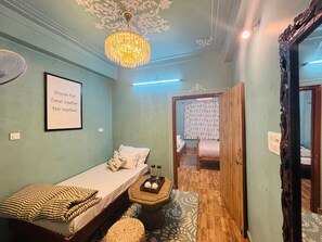 Deluxe Quadruple Room | Living area | Computer monitors, printers - Footprint Hostel Udaipur (Udaipur)