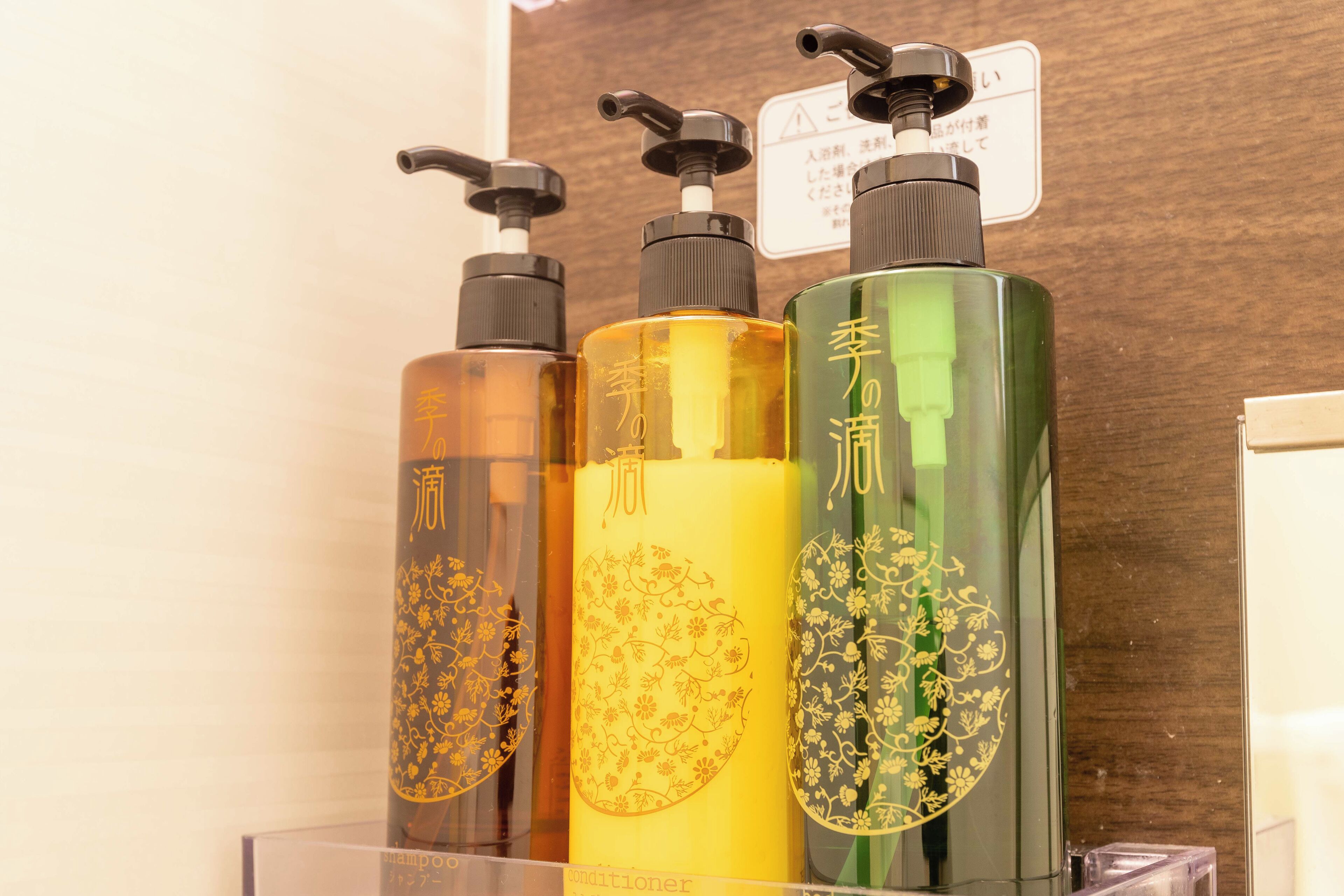 Three bottles of liquid soap with pump dispensers on a display.