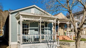 A two-story house with a porch and a small front yard.