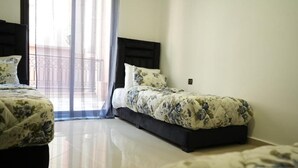 A hotel room with two beds, a large window with sheer curtains, and a balcony. - Bayt al atlas (Marrakech)