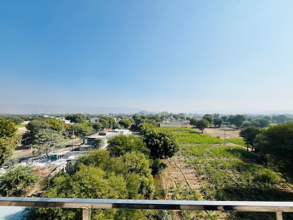 A rural landscape with scattered buildings, trees, and fields.