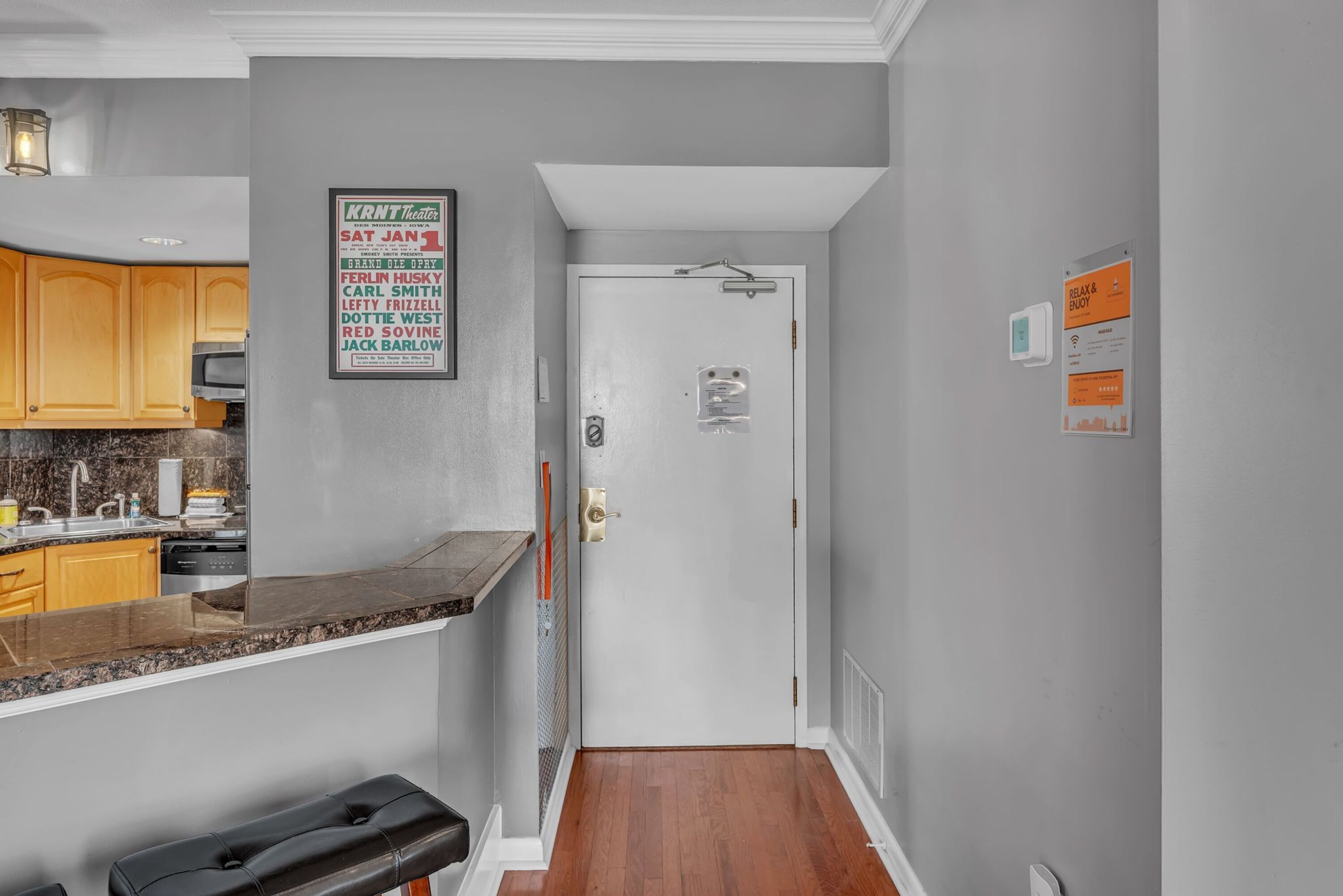 A modern kitchen with granite countertops, wooden cabinets, and a built-in dishwasher.