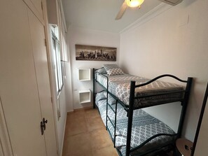 3 dormitorios, tabla de planchar con plancha, ropa de cama