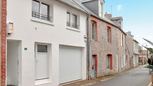 A row of two-story buildings with white facades and red brick accents. - 1 bedroom nice apartment in Carolles (Carolles)